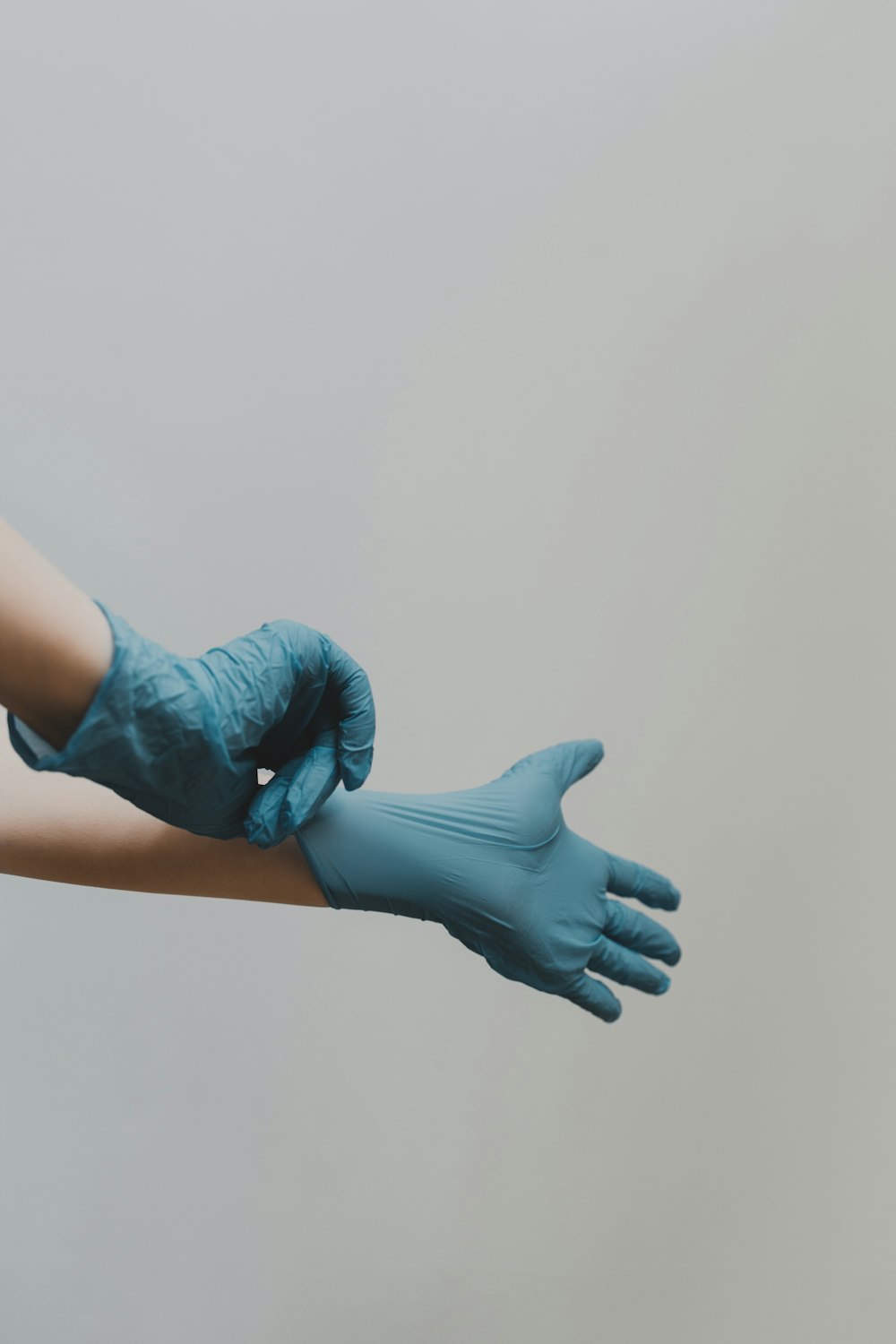 A cleaner pulling on fresh protective gloves