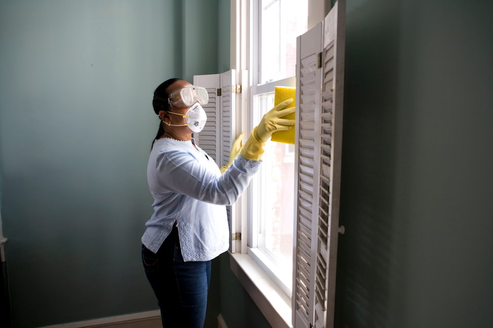 A Vertex team member detailing a window